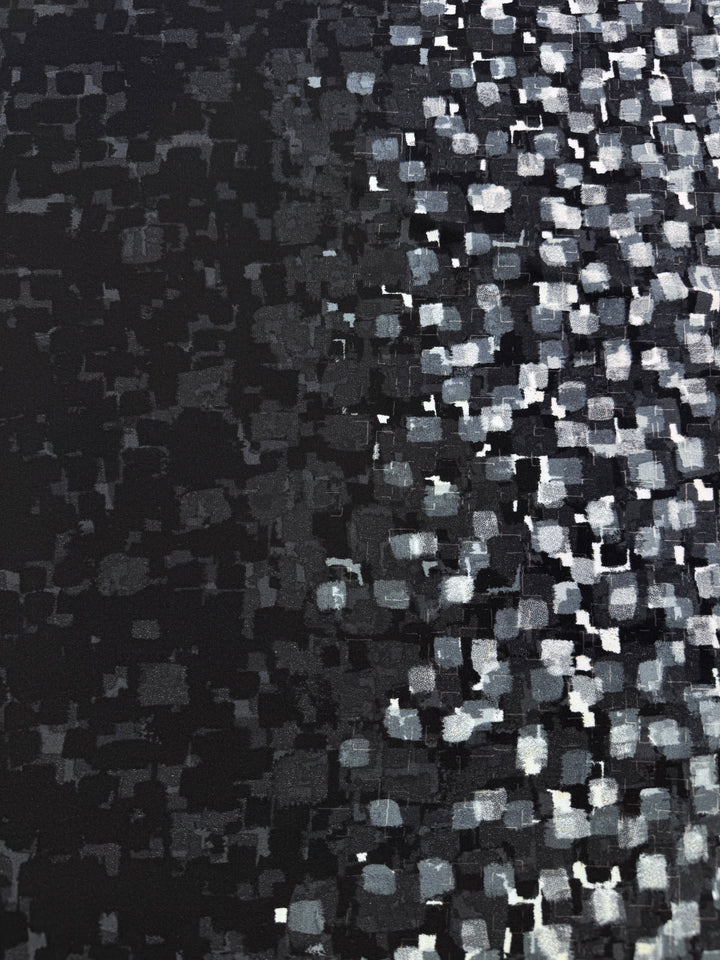 The Designer Lycra Panel - 90cm Panel by Super Cheap Fabrics features small, irregular white and gray squares on black, forming a light-to-dark gradient. Each panel measures 90cm in length and 150cm in width.