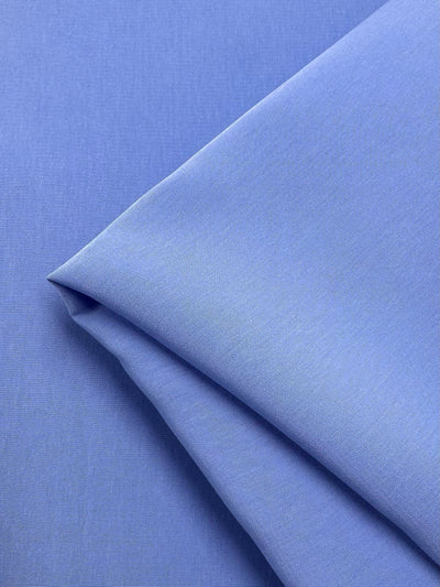 The Microfibre Suiting - Azurine by Super Cheap Fabrics features a neatly folded, smooth microfibre surface with a soft sheen and medium weight, highlighting its crispness and quality. Width: 150cm.