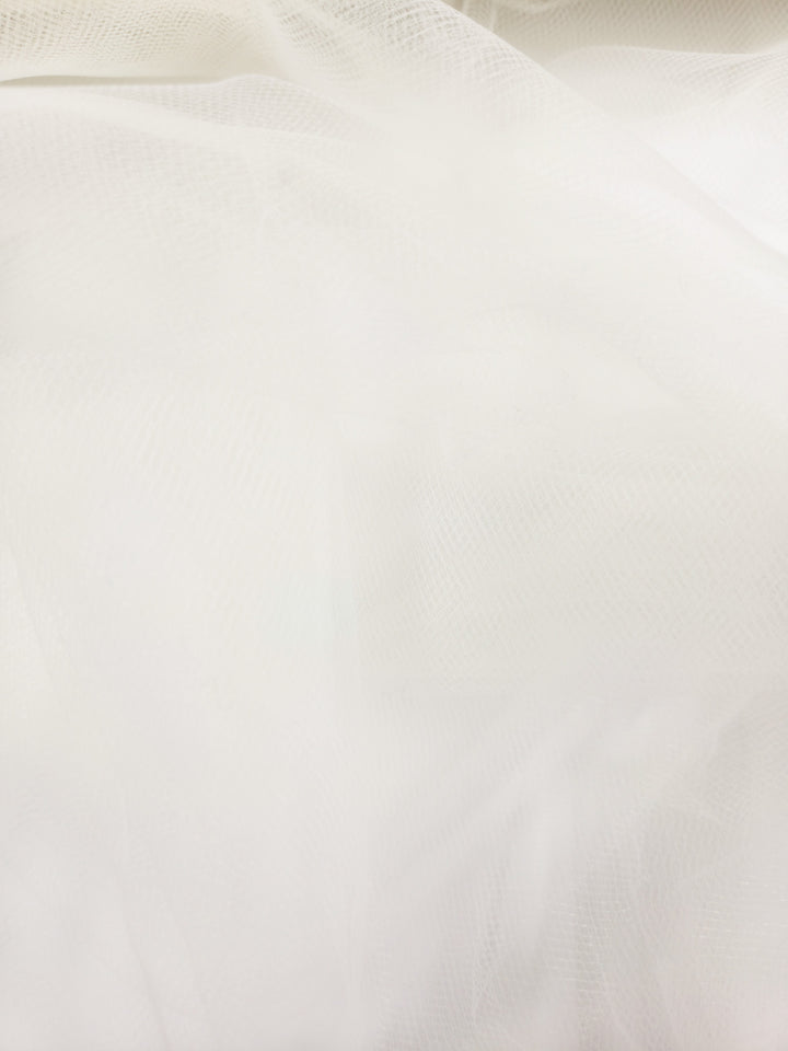 Soft Tulle - Cream - 150cm by Super Cheap Fabrics features a soft, translucent texture and subtle mesh pattern for gentle folds and an airy look—perfect for bridal veils and lightweight projects.