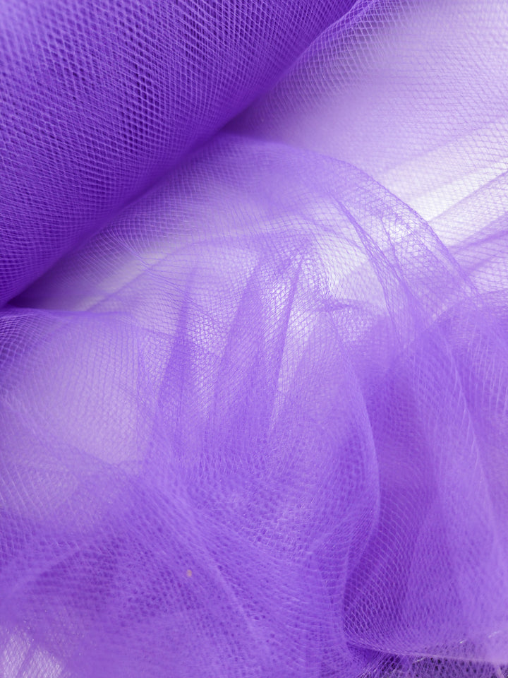 A close-up of Super Cheap Fabrics' Soft Tulle - Purple - 150cm showcases its fine netting texture and delicate drape, ideal for creating lightweight, elegant bridal veils.