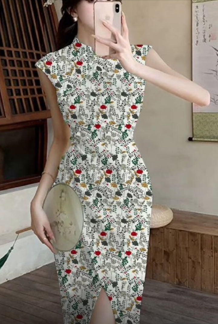 A woman takes a mirror selfie in a fitted, sleeveless cheongsam dress made from Super Cheap Fabrics’ Designer Rayon - Petal Grid - 145cm, featuring a floral botanical pattern. She holds a round fan and stands indoors near traditional decor.