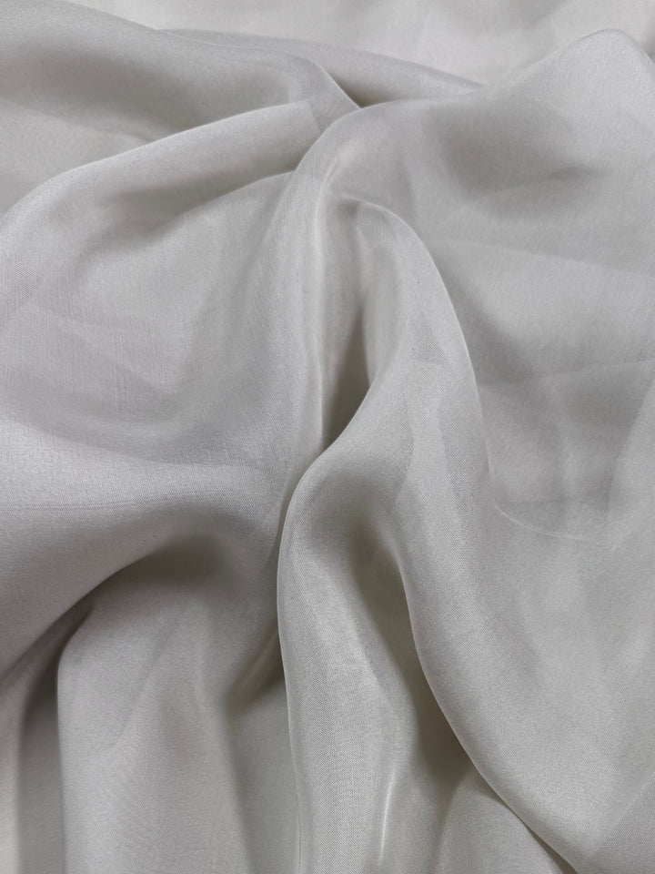 Pure Silk Chiffon - Oyster by Super Cheap Fabrics is a sheer, white silk chiffon with subtle shine and soft drape—ideal for airy, elegant summer outfits. Width: 140cm.