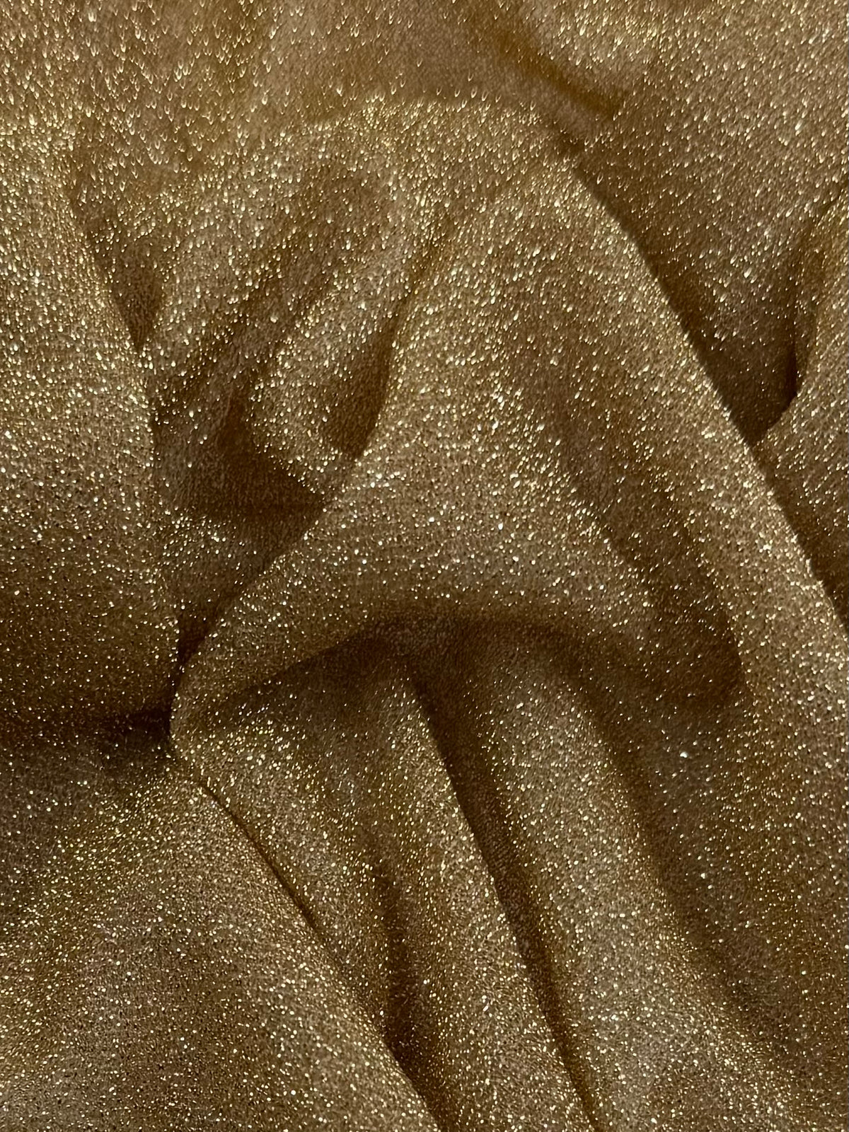 Gold metallic textured knit fabric close up