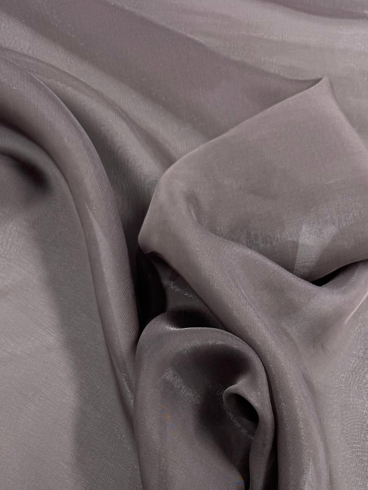 A close-up of Super Cheap Fabrics’ Blended Silk Mousseline in Pewter (147cm), a soft, sheer polyester-silk fabric with a subtle sheen, shown gently draped in loose folds.