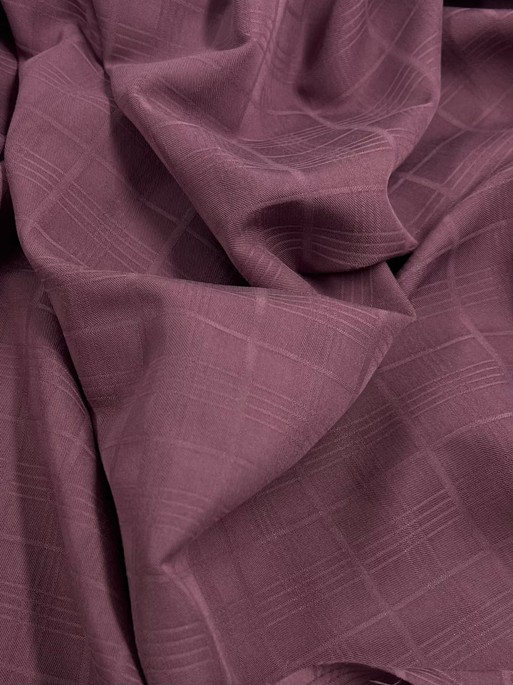 Suiting - Mauve Tartan by Super Cheap Fabrics features a lightweight, wrinkled mauve fabric with a subtle, elegant tartan pattern, creating soft folds and gentle shadows.