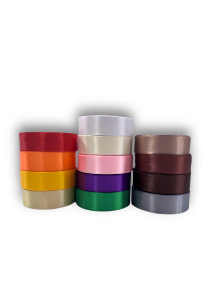 Super Cheap Fabrics' Satin Ribbon - 16 Colours - 25mm set features twelve vibrant rolls, neatly stacked in three columns on a white background, showcasing shades such as red, gold, pink, green and more from the full 16-color range.
