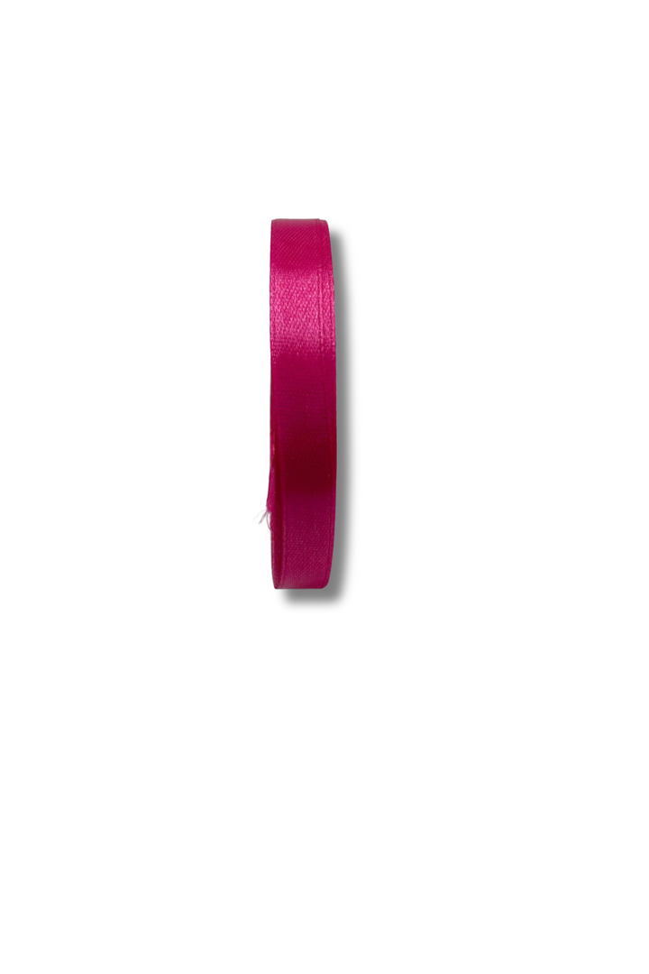 A Super Cheap Fabrics Satin Ribbon (10 Colours, 10mm x 21m, bright pink) roll is positioned vertically on a white background, casting a soft shadow to the right.