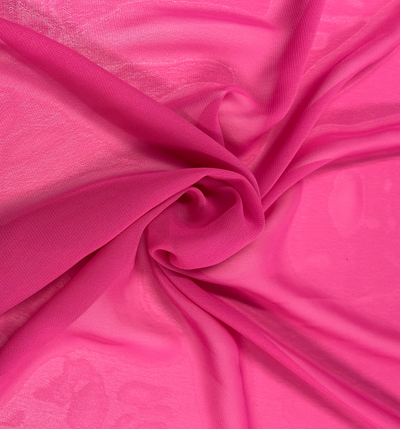 Close-up of the Hi-Multi Chiffon in hot pink, a fabric by Super Cheap Fabrics, elegantly arranged in a loose spiral. This 150cm wide polyester material forms a textured, swirling pattern. Its lightweight nature makes it appear soft and airy, with gentle folds and subtle shadows enhancing its delicate appearance.