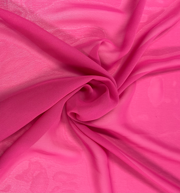 Close-up of the Hi-Multi Chiffon in hot pink, a fabric by Super Cheap Fabrics, elegantly arranged in a loose spiral. This 150cm wide polyester material forms a textured, swirling pattern. Its lightweight nature makes it appear soft and airy, with gentle folds and subtle shadows enhancing its delicate appearance.