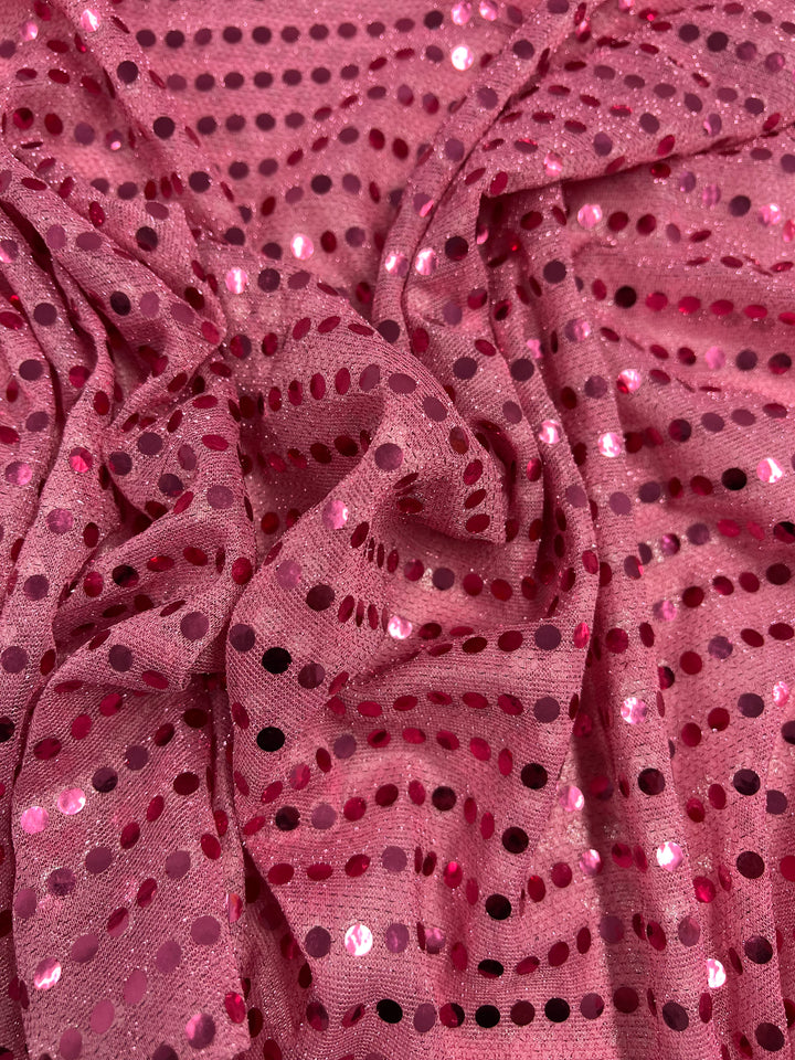 Super Cheap Fabrics' Sequin - Pink - 112cm features shiny, reflective sequin dots on pink fabric with a gathered texture. Ideal for dancewear or standout costumes.