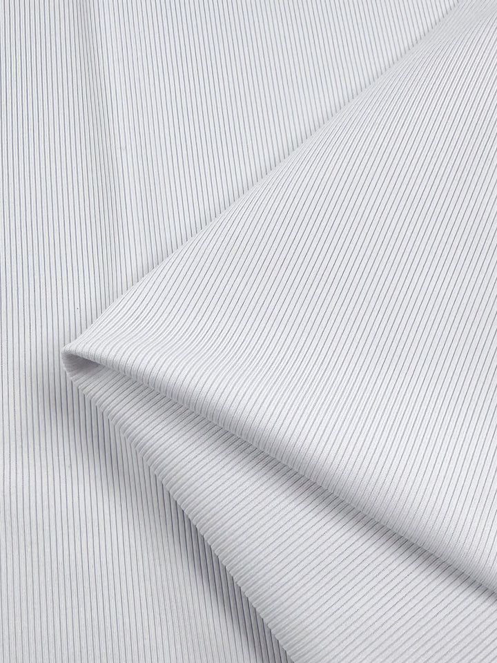 A close-up of Super Cheap Fabrics’ Rib Knit 1x1 - White - 124cm shows neatly folded medium-weight fabric with fine vertical blue pinstripes on a white background, creating a clean, orderly appearance.