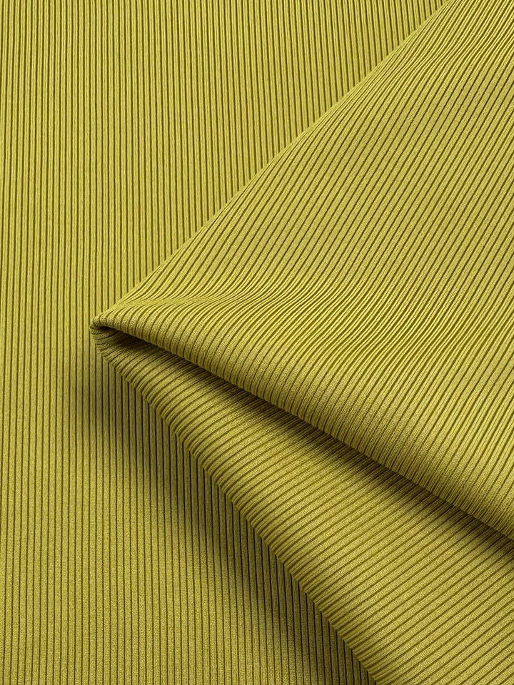 Close-up of Rib Knit 1x1 - Squash fabric by Super Cheap Fabrics, featuring a green, medium-weight rib knit with a folded edge that adds depth and softness.
