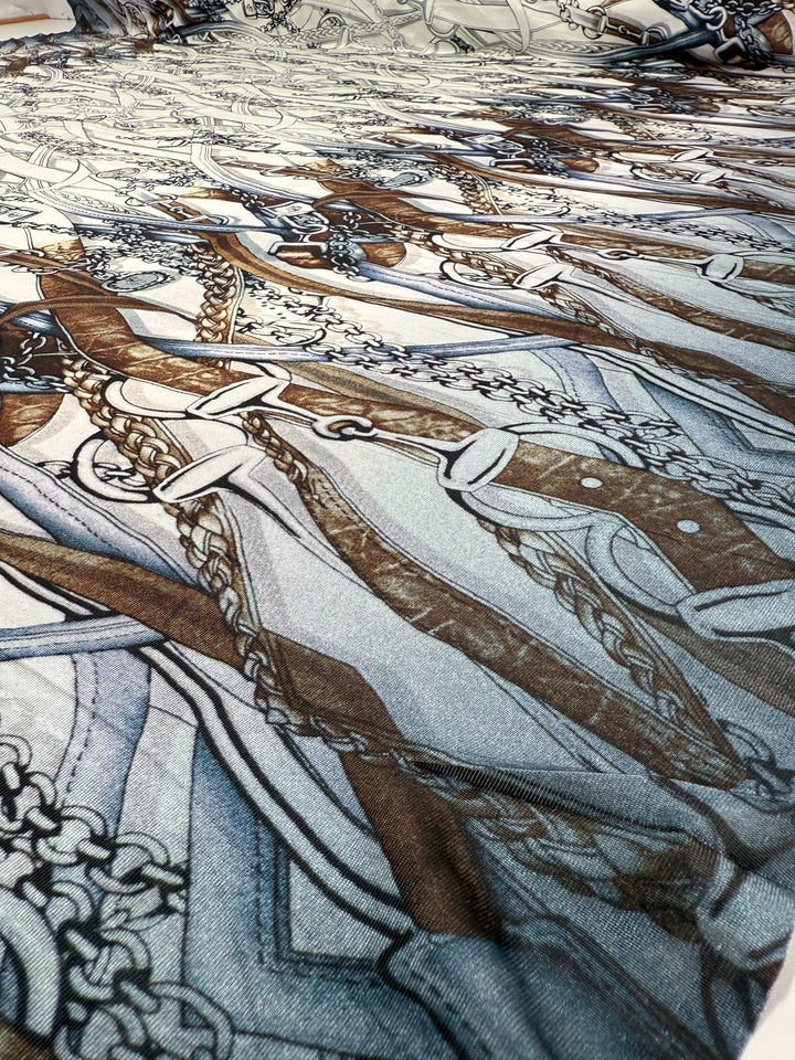 Close-up of Super Cheap Fabrics’ Viscose Knit - Link - 138cm: a patterned stretch fabric featuring interwoven brown and gray swords with ornate handles and chain designs, creating a layered, repeating effect.