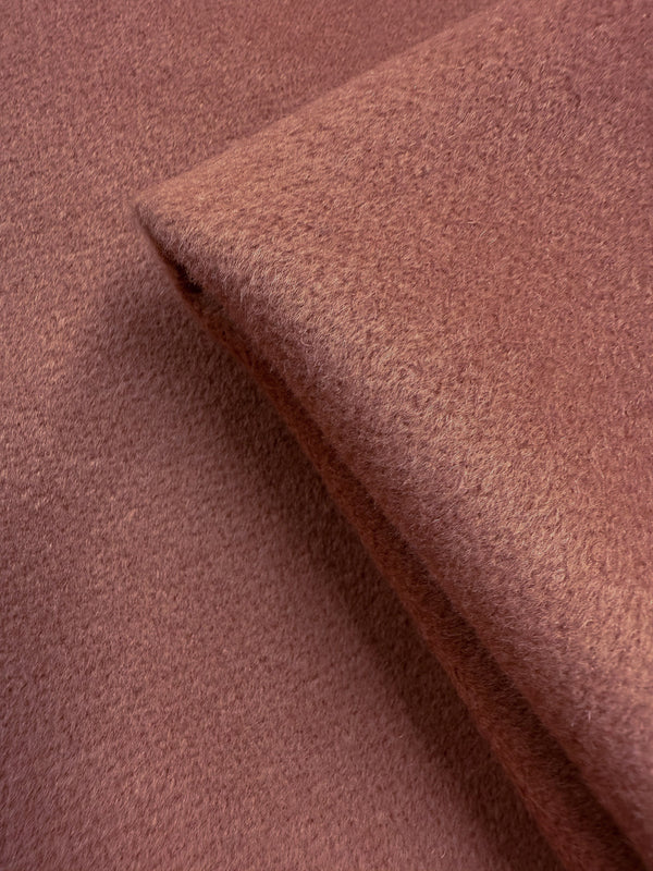 A close-up of Wool Cashmere - Canyon Clay (150cm) by Super Cheap Fabrics, showing its soft, textured rose-toned heavyweight fabric neatly folded with a fuzzy surface and subtle sheen.