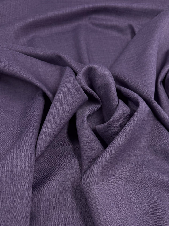 Super Cheap Fabrics' Twill Suiting - Wineberry - 150cm features softly crumpled purple fabric with gentle folds and creases, creating subtle shadows and highlights across its versatile texture.