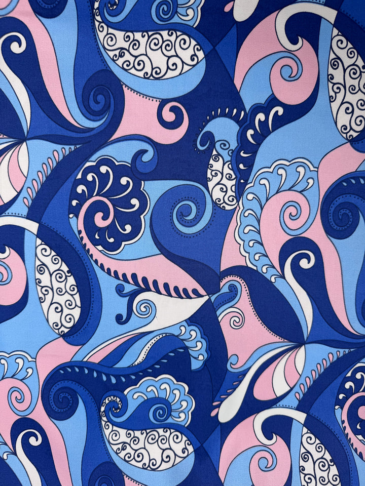 Serenity Waves by Super Cheap Fabrics is a vibrant abstract cotton sateen (148cm) with swirling blue, pink, and white patterns and paisley-like details—lightweight, decorative, and ideal for versatile projects.