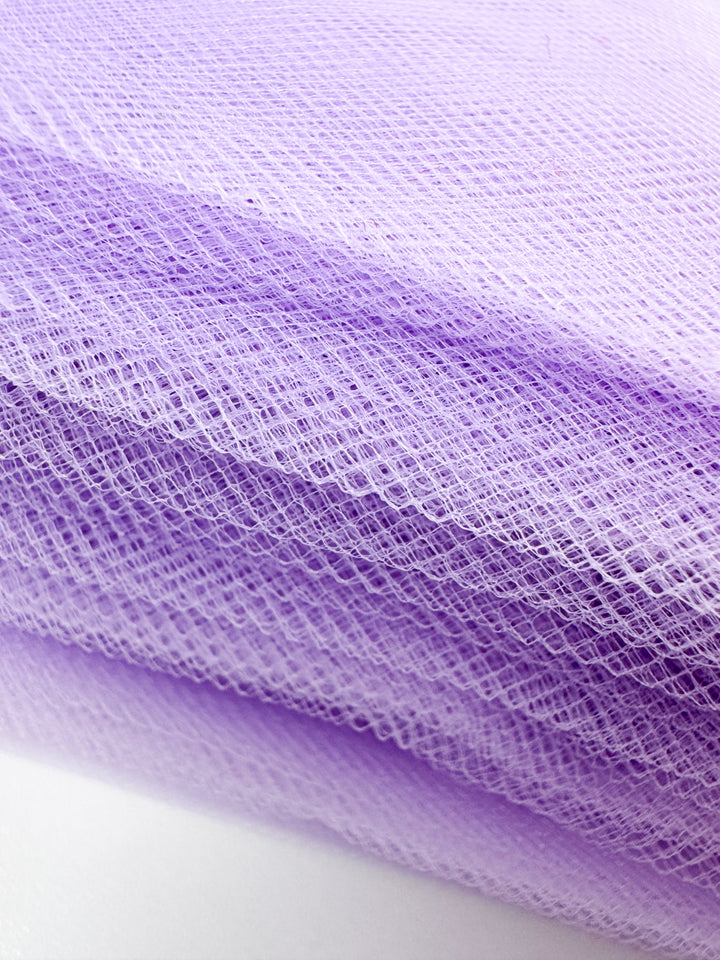 Close-up of Super Cheap Fabrics’ Soft Tulle - Lavender - 150cm, highlighting its delicate, mesh-like texture and soft, translucent look—ideal for bridal veils and craft projects.