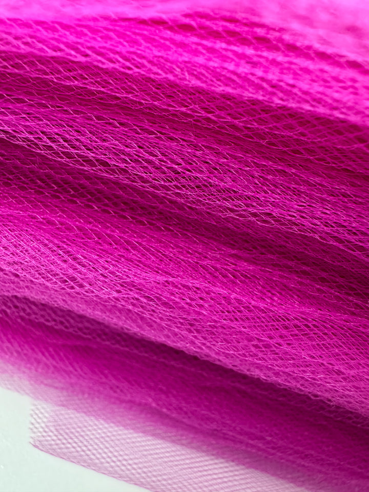 Close-up of "Soft Tulle - Very Berry - 150cm" by Super Cheap Fabrics, showing its fine mesh texture and semi-transparent, airy look—ideal for costumes, bridal veils, and decorative projects.