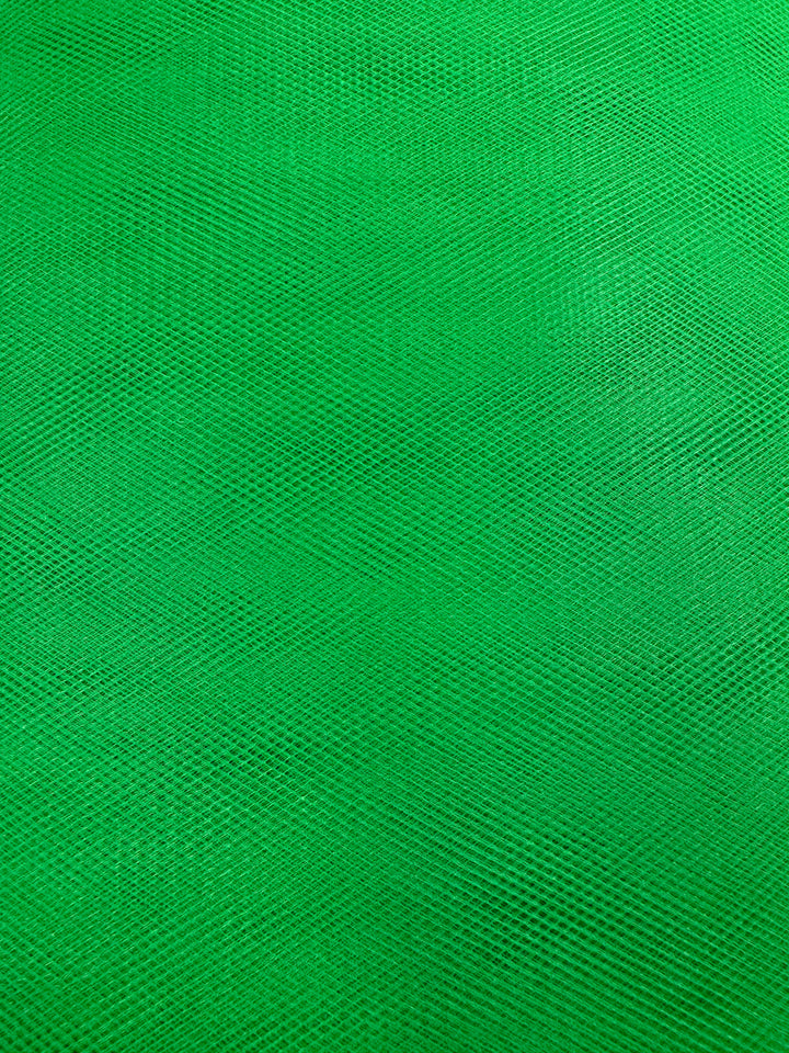 Close-up of Super Cheap Fabrics' Soft Tulle in Emerald (150cm), featuring a fine, crisscross mesh pattern and a subtle geometric design that captures the lightweight, textured look of classic tulle.