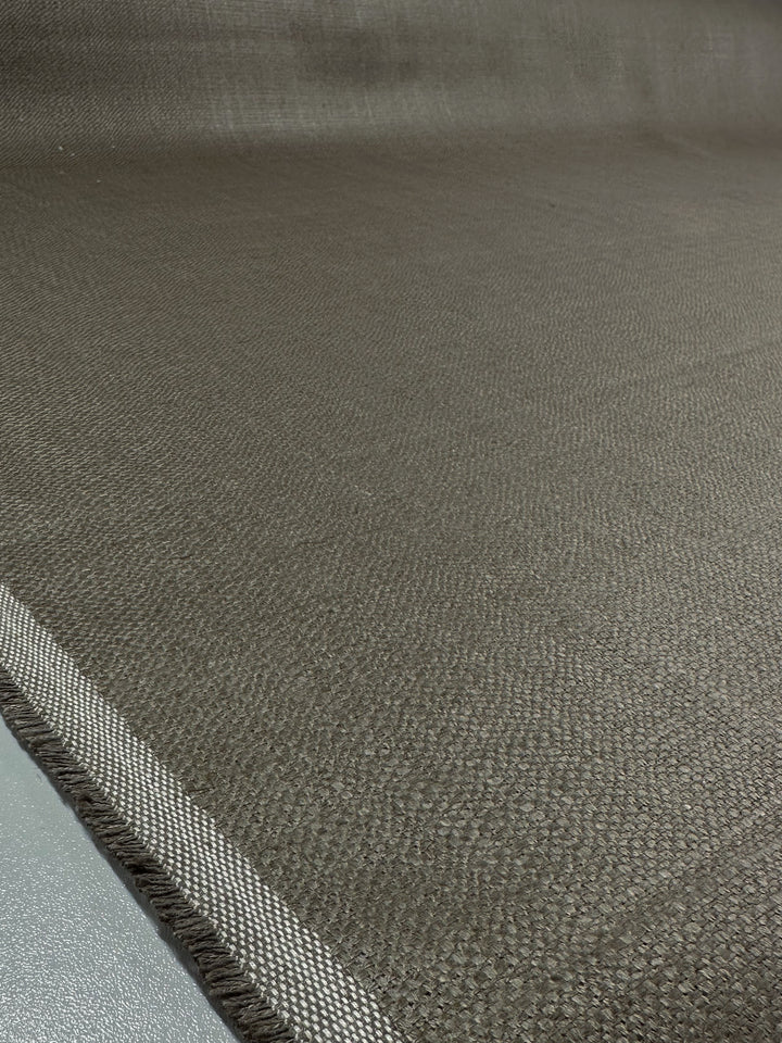 The Upholstery Basket Weave in Dorian Putty by Super Cheap Fabrics showcases a textured, thick, and woven design with white-striped edges, laid flat on a light gray surface to highlight its pattern. Width: 145cm.