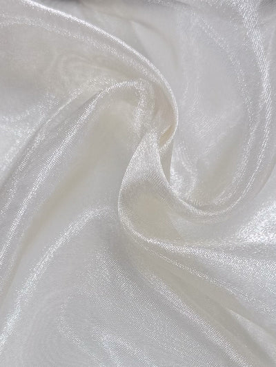 Close-up of "Organza - Winter Wheat - 150cm" from Super Cheap Fabrics: smooth, shiny sheer fabric with a translucent texture and gentle folds—ideal for elegant wedding dress material.