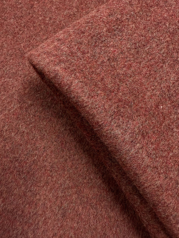 A close-up of Super Cheap Fabrics' Wool Cashmere - Marsala Marle (150cm), highlighting its reddish-brown hue, soft fibers, textured weave, and slightly fuzzy surface.