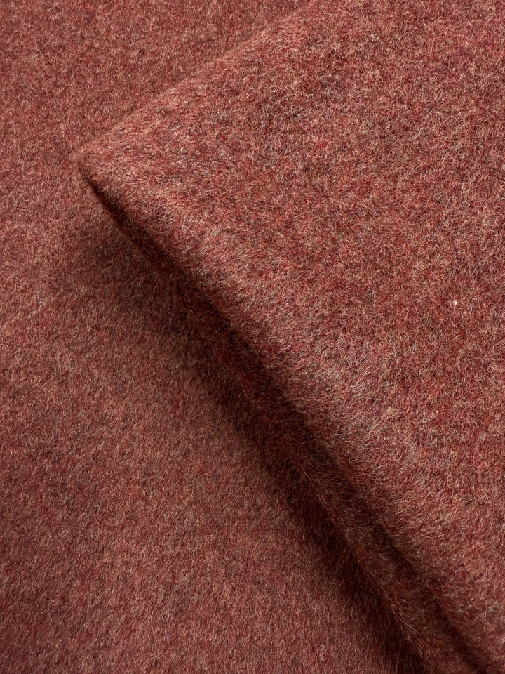 A close-up of Super Cheap Fabrics' Wool Cashmere - Marsala Marle (150cm), highlighting its reddish-brown hue, soft fibers, textured weave, and slightly fuzzy surface.