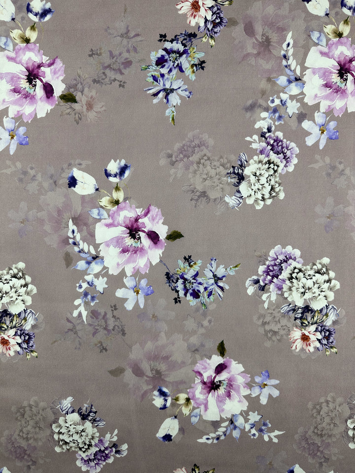 The Cotton Sateen - Shadow Rose by Super Cheap Fabrics features pink, purple, and white flowers on a soft taupe background, showcasing delicate blooms in a vintage style. The lightweight cotton fabric includes elastane for enhanced comfort and stretch. Width: 120cm.
