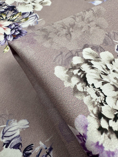 Close-up of Super Cheap Fabrics' Cotton Sateen - Shadow Rose fabric, 120cm wide, showcasing a lightweight cotton blend with elastane. Features a subtle sheen and floral pattern in purple, white, and gray for a soft, elegant look.