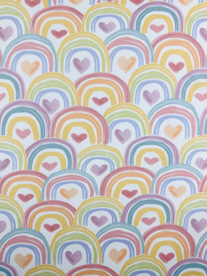 The Printed Delsutered Satin - Unity by Super Cheap Fabrics features vibrant pastel rainbow arches with heart centers on lightweight fabric. Its soft sheen enhances the cheerful design, creating a harmonious and delightful effect across its 155cm width.