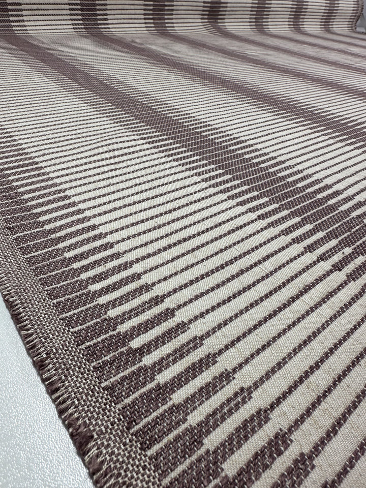 Close-up of Super Cheap Fabrics’ Striped Woven Upholstery - Melmoth (142cm), featuring brown and beige diagonal and vertical stripes in an abstract, geometric pattern inspired by burlwood, laid flat on a surface.