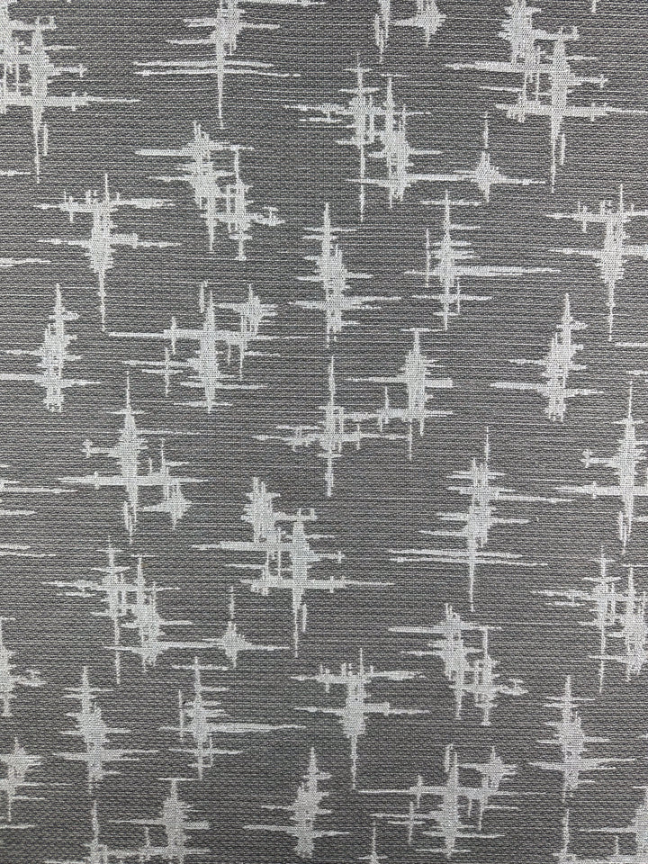 The Abstract Woven Upholstery - Morissey by Super Cheap Fabrics features a modern pattern of white abstract sound waves on a gray background, ideal for contemporary furniture. Width: 147cm.