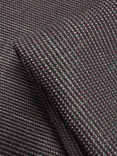 Close-up of Grid Upholstery - Yari 125 (147cm) by Super Cheap Fabrics, showing folded, heavyweight fabric with a woven black and dark purple grid pattern, textured surface, and subtle sheen.