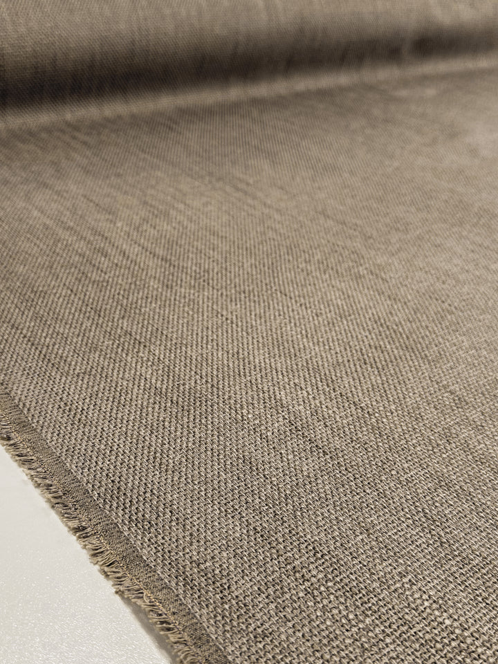 A close-up of Super Cheap Fabrics' Textured Woven Upholstery - Osaka Clay (143cm) shows its coarse weave and frayed edges, making this heavy, rustic fabric perfect for upholstery and furniture projects.