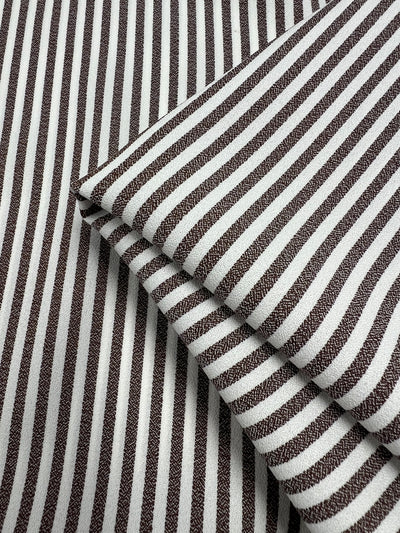 Close-up of Striped Crepe - Fondue Fudge by Super Cheap Fabrics, 150cm wide. Lightweight polyester with brown and white vertical stripes and textured surface, perfect for chic eveningwear.