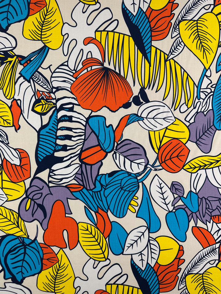 The Bamboo Rayon - Big Boldy (150cm) from Super Cheap Fabrics features a vibrant abstract pattern of tropical leaves in bold colors on a light background, making this lightweight fabric ideal for creative multi-use projects.
