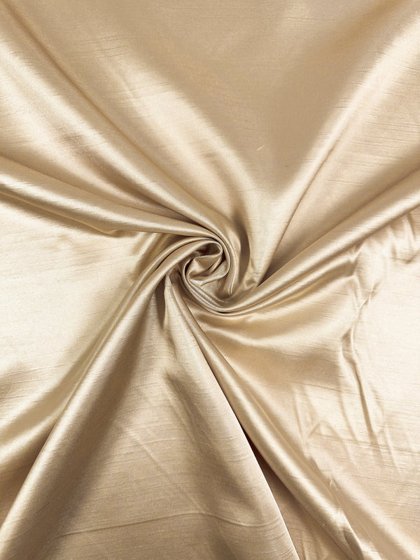 Super Cheap Fabrics' Shantung Satin in Gold (150cm) features a lustrous, light gold finish with smooth, gathered folds and a soft, reflective texture.