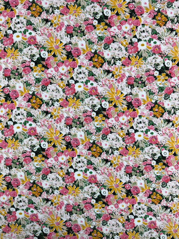 The Designer Rayon - Floral Garden (145cm) from Super Cheap Fabrics features a vibrant, densely packed floral print—pink, white, and yellow blooms with green foliage—perfect for lively, colorful designs.