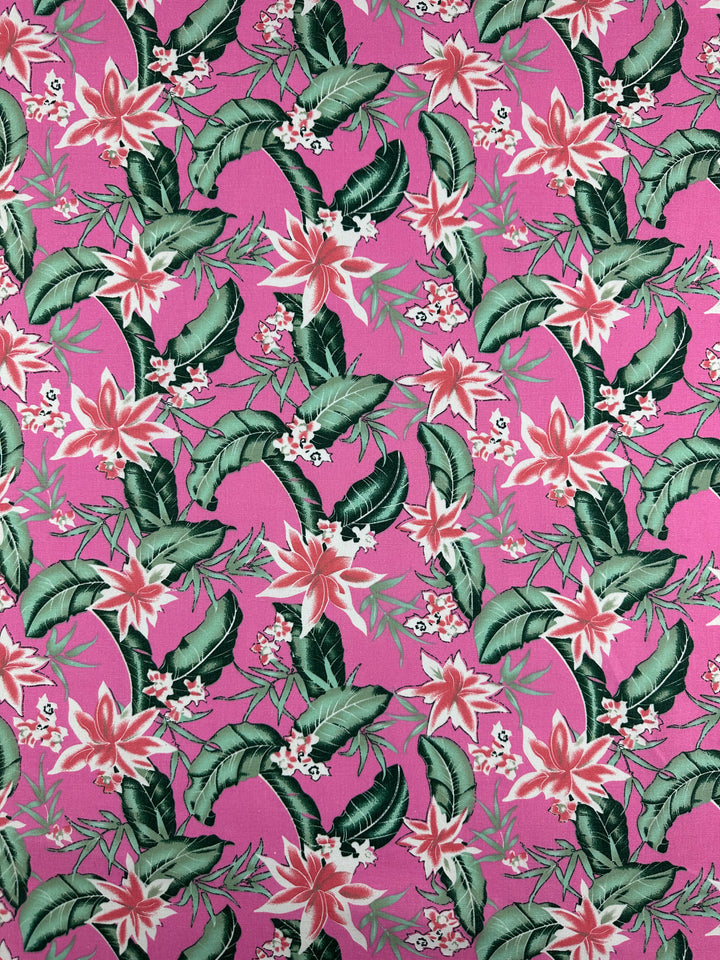 Super Cheap Fabrics' Printed Linen Blend - Jungle Bloom - 140cm features a lively, dense tropical pattern with green leaves and pink and white flowers on bright pink, adding an exotic touch to this medium-weight linen blend.