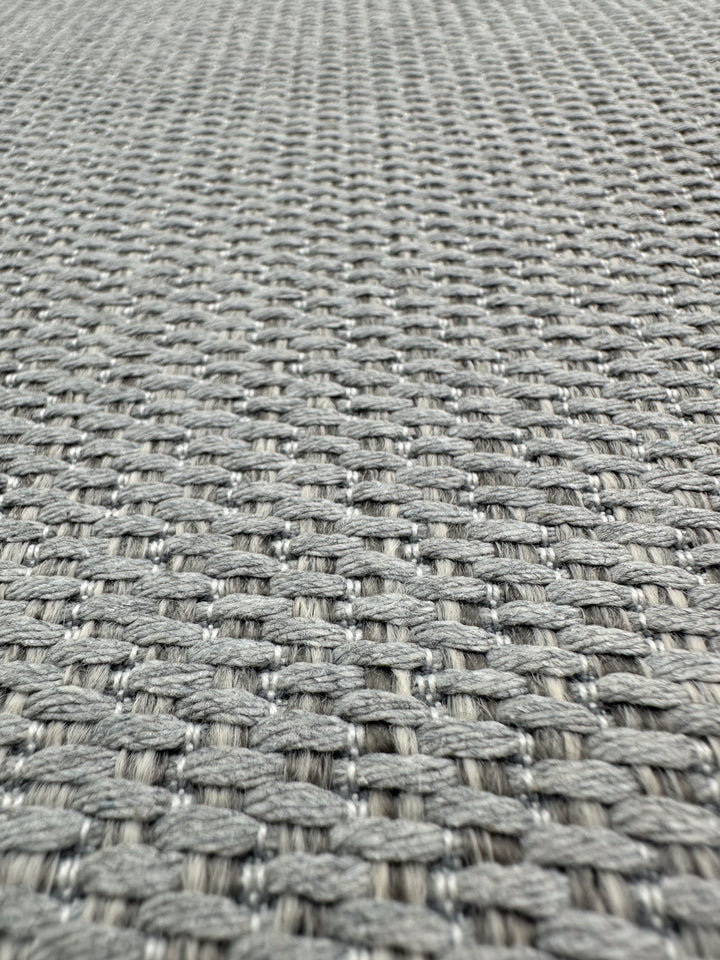 Close-up of Bacchus Silver upholstery fabric by Super Cheap Fabrics, featuring a tightly woven, basket-like gray texture. This premium 145cm wide fabric offers a uniform grid pattern, perfect for upholstery projects.
