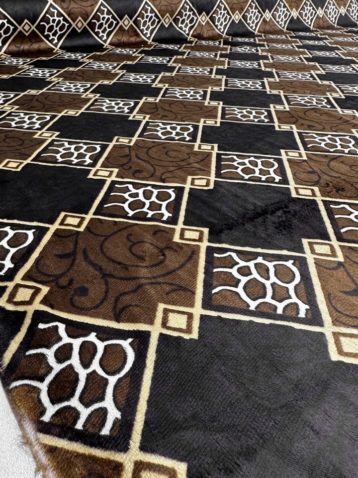 The DD Velvet - Regal Lattice (154cm) from Super Cheap Fabrics is a patterned brown velvet with abstract swirls and white giraffe-like spots bordered by gold lines. Its 100% polyester surface creates an elegant, striking look.