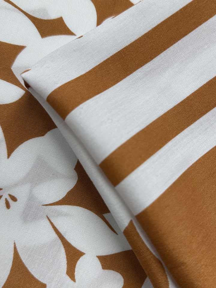 Designer Rayon - Clay Fade from Super Cheap Fabrics features smooth, neatly arranged fabric with a chic white and brown pattern, perfect for stylish and vibrant projects. Width: 145cm.