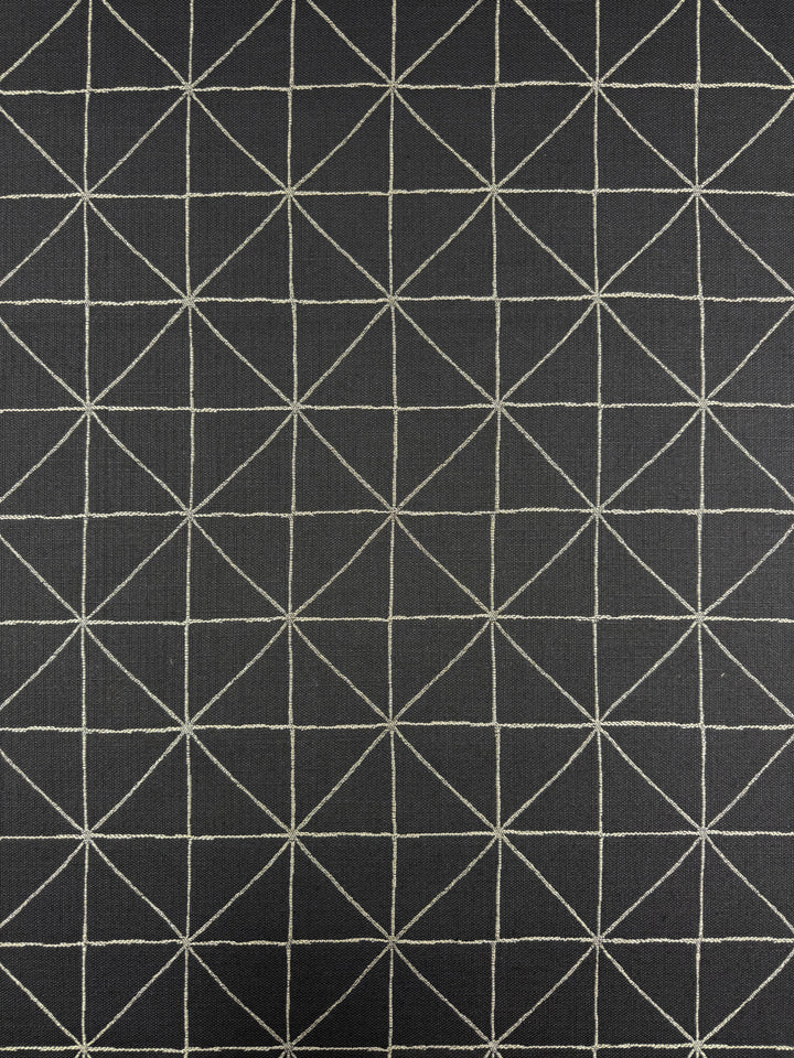 Super Cheap Fabrics’ Linen Viscose - Quentin Coal (156cm) features a heavyweight black linen surface with a geometric grid of white lines forming squares and triangles—ideal for upholstery projects.