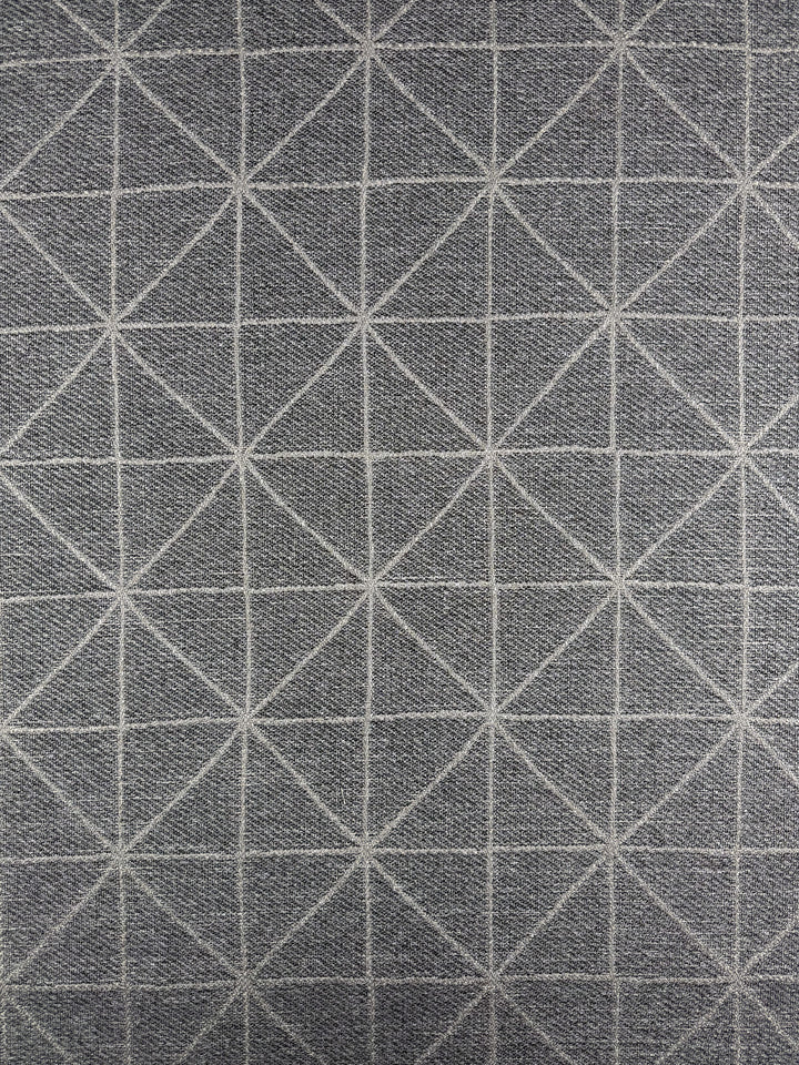 Super Cheap Fabrics' Linen Viscose - Quentin Silver (156cm) features a gray luxurious woven fabric with a geometric grid of white triangles and diamonds, made from extra heavy weight linen. The symmetrical design is evenly spaced across the surface.
