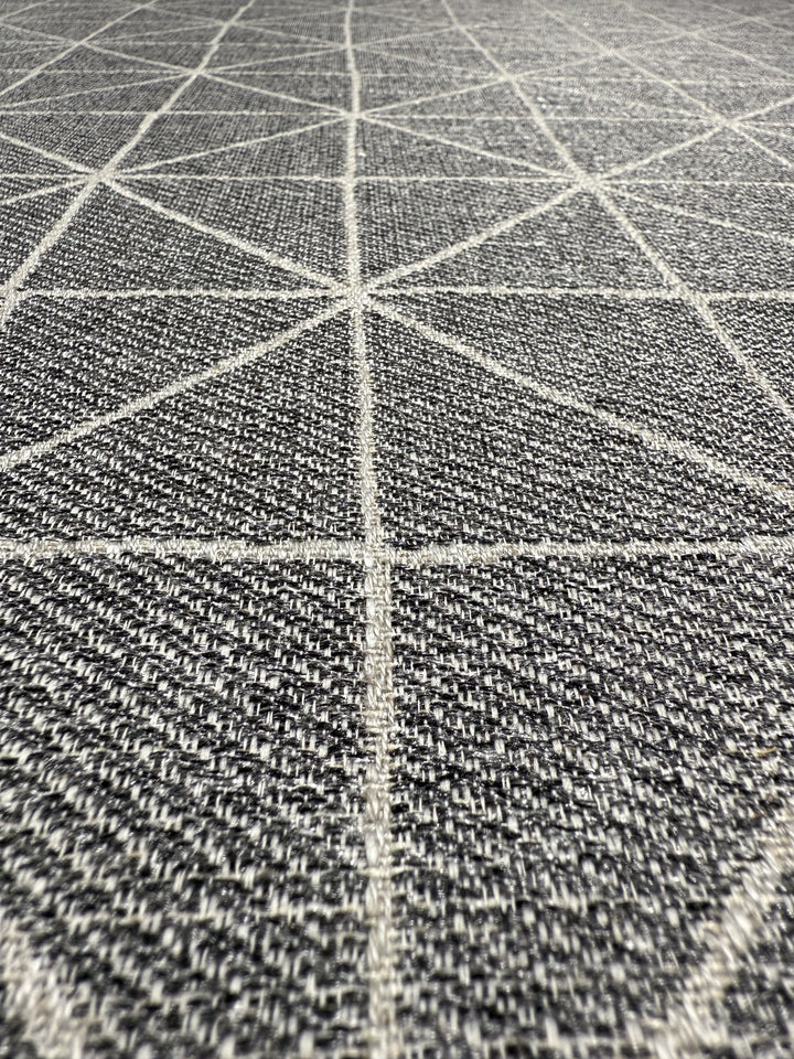 Close-up of Super Cheap Fabrics’ Linen Viscose - Quentin Silver (156cm), featuring detailed fibers and a textured gray surface with a geometric pattern of intersecting white lines forming diamonds and triangles.