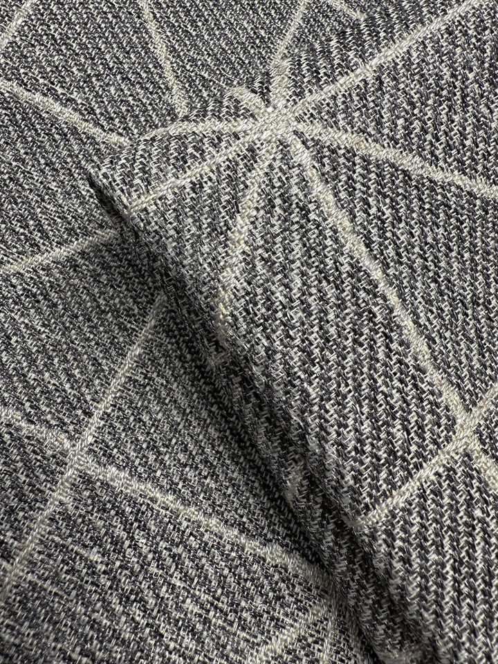 Close-up of Super Cheap Fabrics’ Linen Viscose - Quentin Silver (156cm), showcasing a soft, extra heavy weight fabric with a gray and white geometric pattern of intersecting lines. Limited stock available.