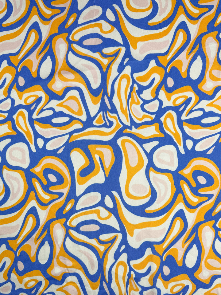 Mercerised Rayon - Electric Ember by Super Cheap Fabrics features vibrant swirling orange, white, and pink patterns on blue. This 145cm rayon is dynamic, organic, and lightweight—ideal for breathable creations.