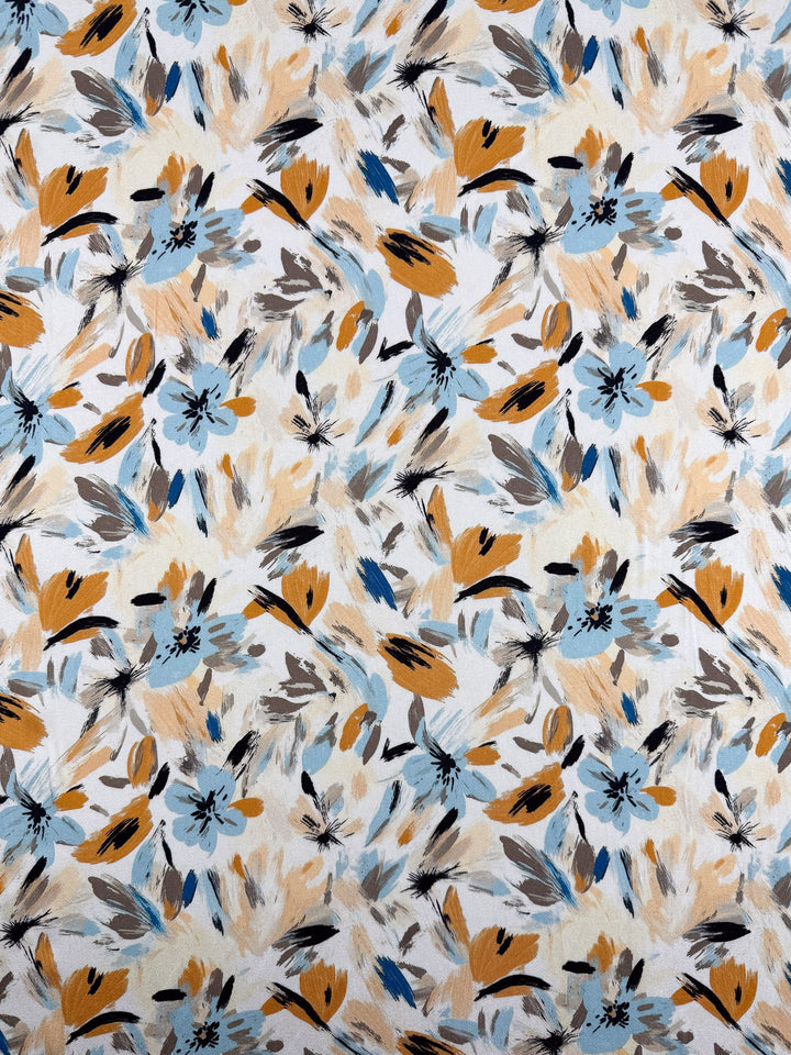 Mercerised Rayon - Autumn Haze by Super Cheap Fabrics features a lively abstract floral pattern in light blue, mustard yellow, black, and beige on white breathable rayon fabric. Width: 150cm.