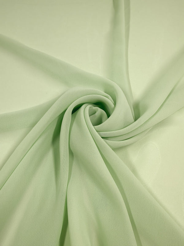 Super Cheap Fabrics' Hi-Multi Chiffon in pastel green (150cm) is a lightweight, delicate, and slightly sheer fabric with a soft texture that creates gentle folds and smooth, swirling patterns.