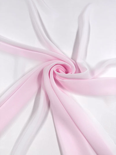 The Hi-Multi Chiffon - Calcite Pink (150cm) from Super Cheap Fabrics features sheer pale pink polyester arranged in a spiral on white, giving a soft, elegant, and flowing look.